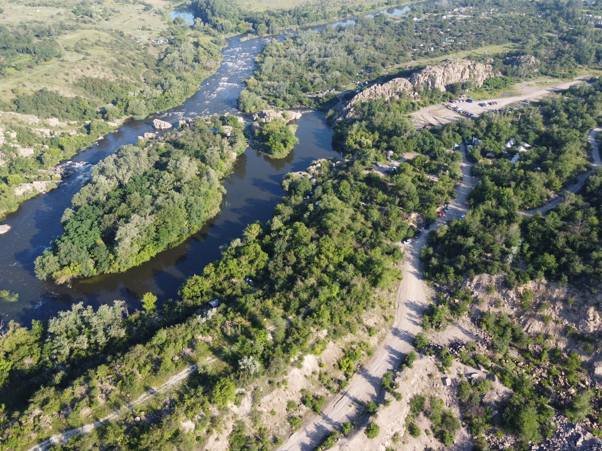 Aerial river landscape with rocky terrain and green surroundings
