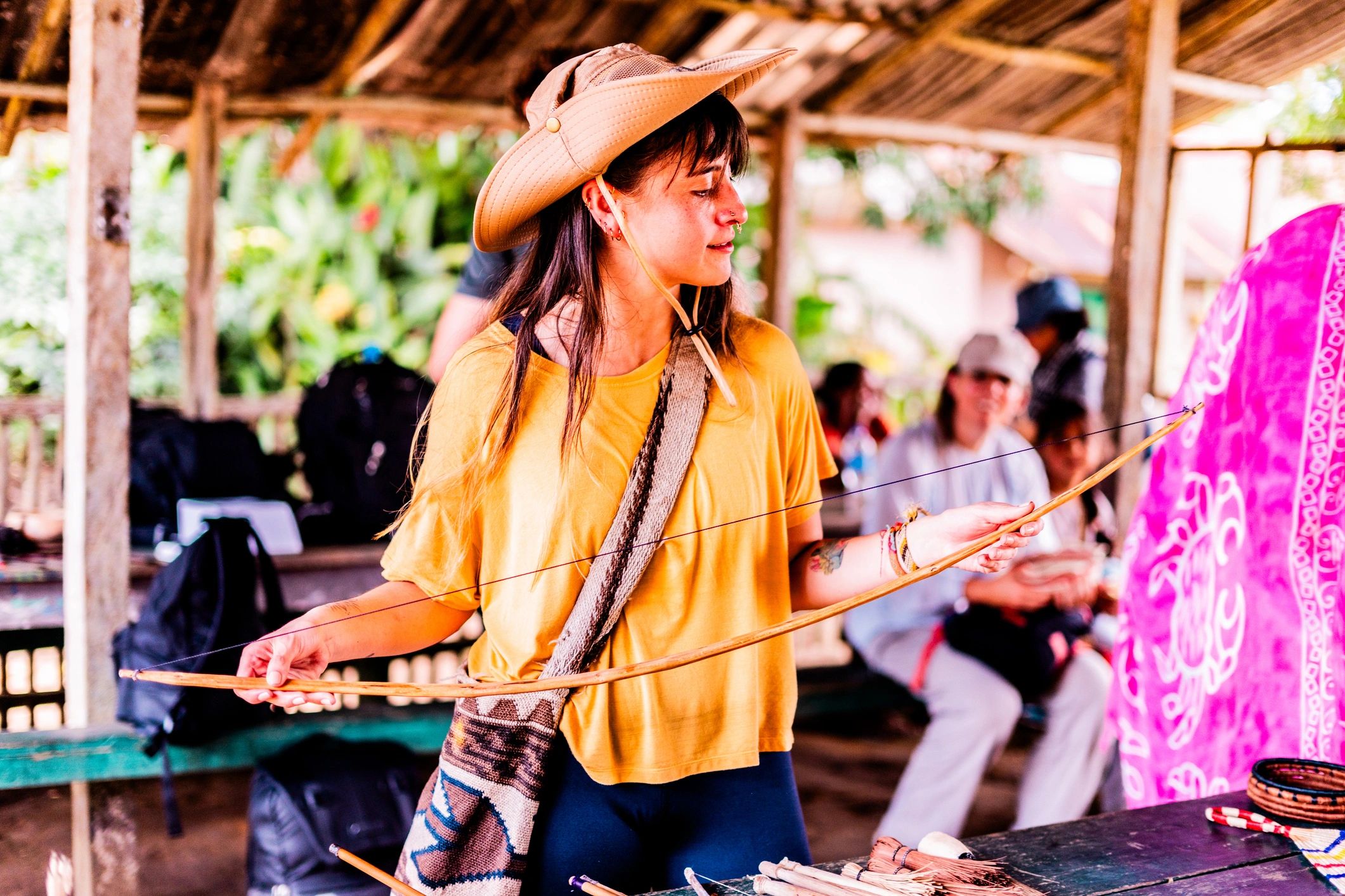 Tourist exploring traditional handcrafted baskets in indigenous tribe, Guainia Department, Colombia