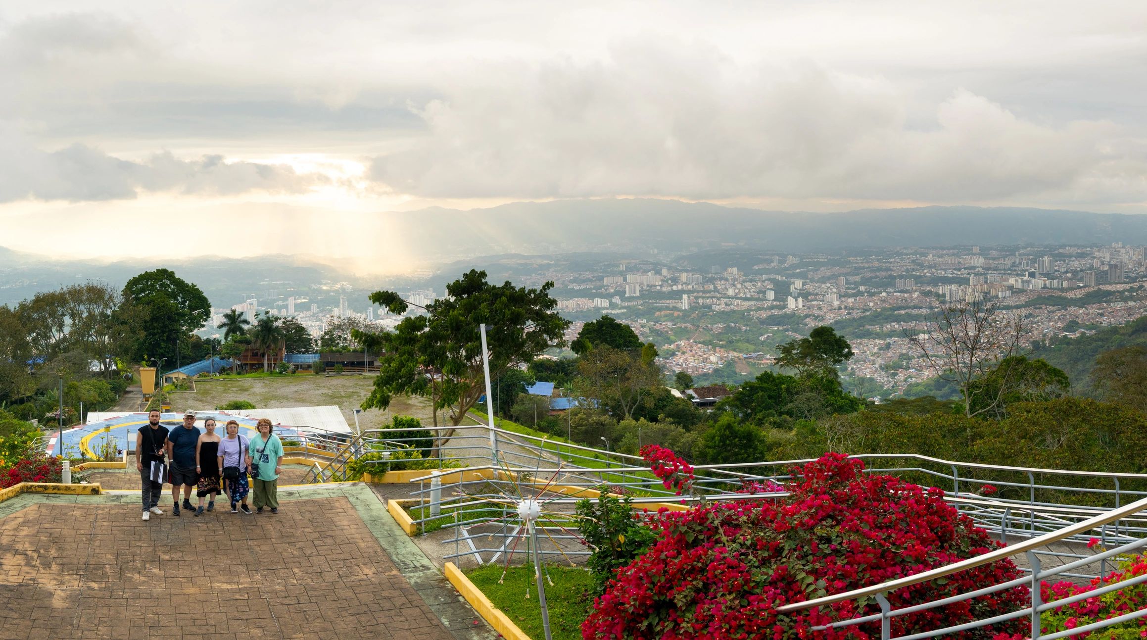 Family at Hilltop Viewpoint Overlooking City Panorama